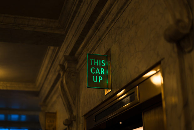 photo of an elevator sign "this car up"