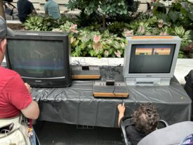 Two Atari 2600 home gaming consoles at SAAM Arcade with the games Moon Patrol and Dig Dug.