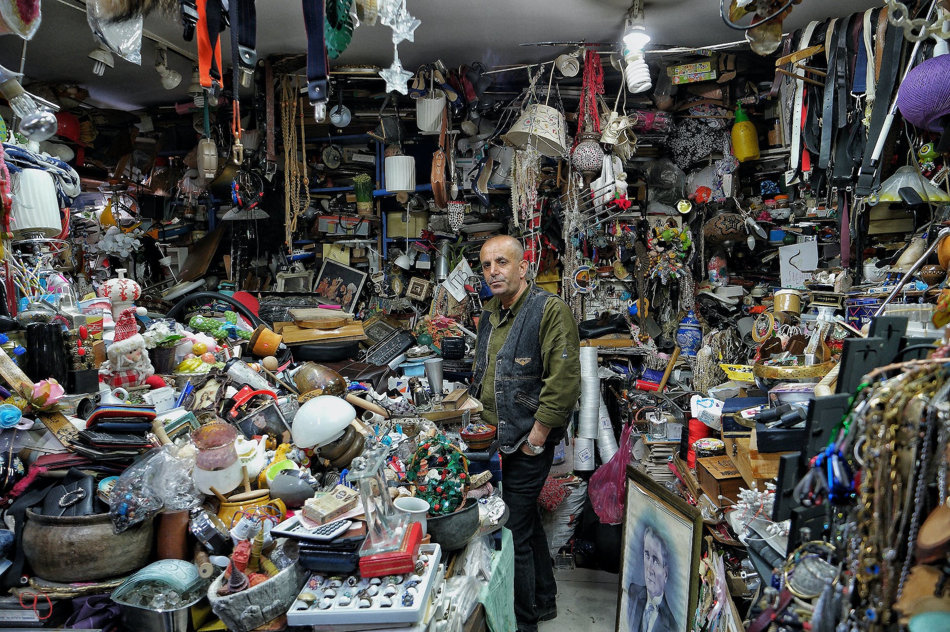 man standing in a cluttered antiques shop