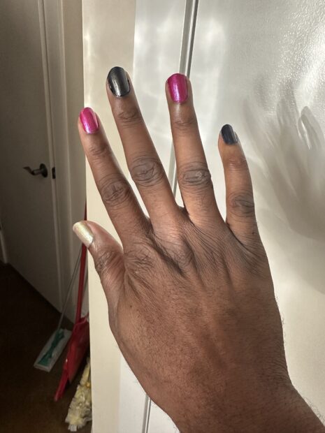 Home birthday manicure. Red and black alternating fingertips with iridescent thumbs.