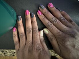 Home manicure for my birthday. Red and black alternating finger tips with iridescent polish on the thumbs.
