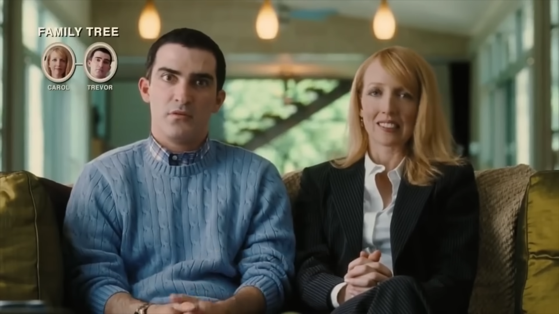 Screen grab from the movie Idiocracy. It shows a man and woman, Trevor and Carol as they are interviewed about whether they want to have children. In the upper left is a graphic showing their family tree and that it is still just the two of them.